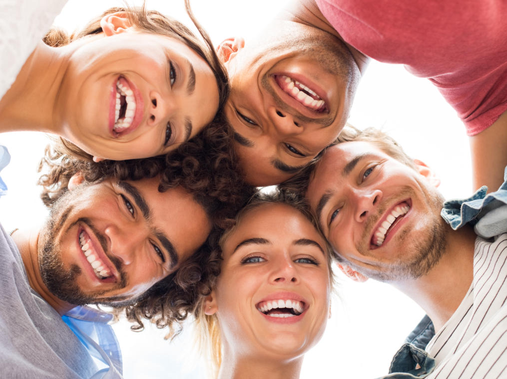 Multicultural group of happy young people with perfect smiles.