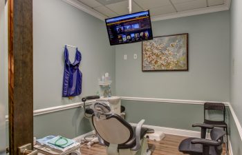 Treatment room with flatscreen TV at Green Meadow Dental