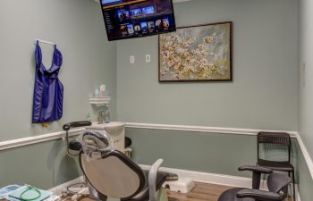 Treatment room with flatscreen TV at Green Meadow Dental