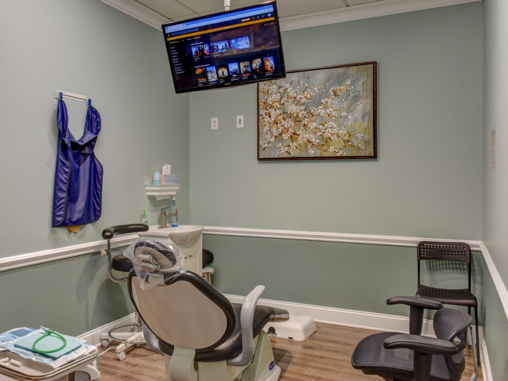 Treatment room with flatscreen TV at Green Meadow Dental